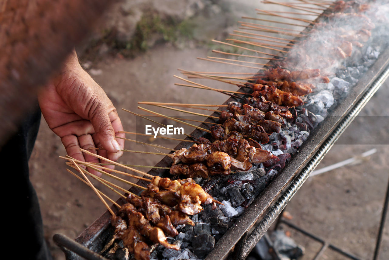 The seller is grilled satay. 