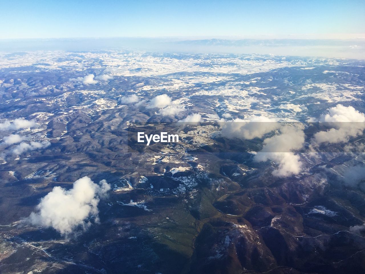 AERIAL VIEW OF CLOUDS OVER LANDSCAPE AND CITYSCAPE