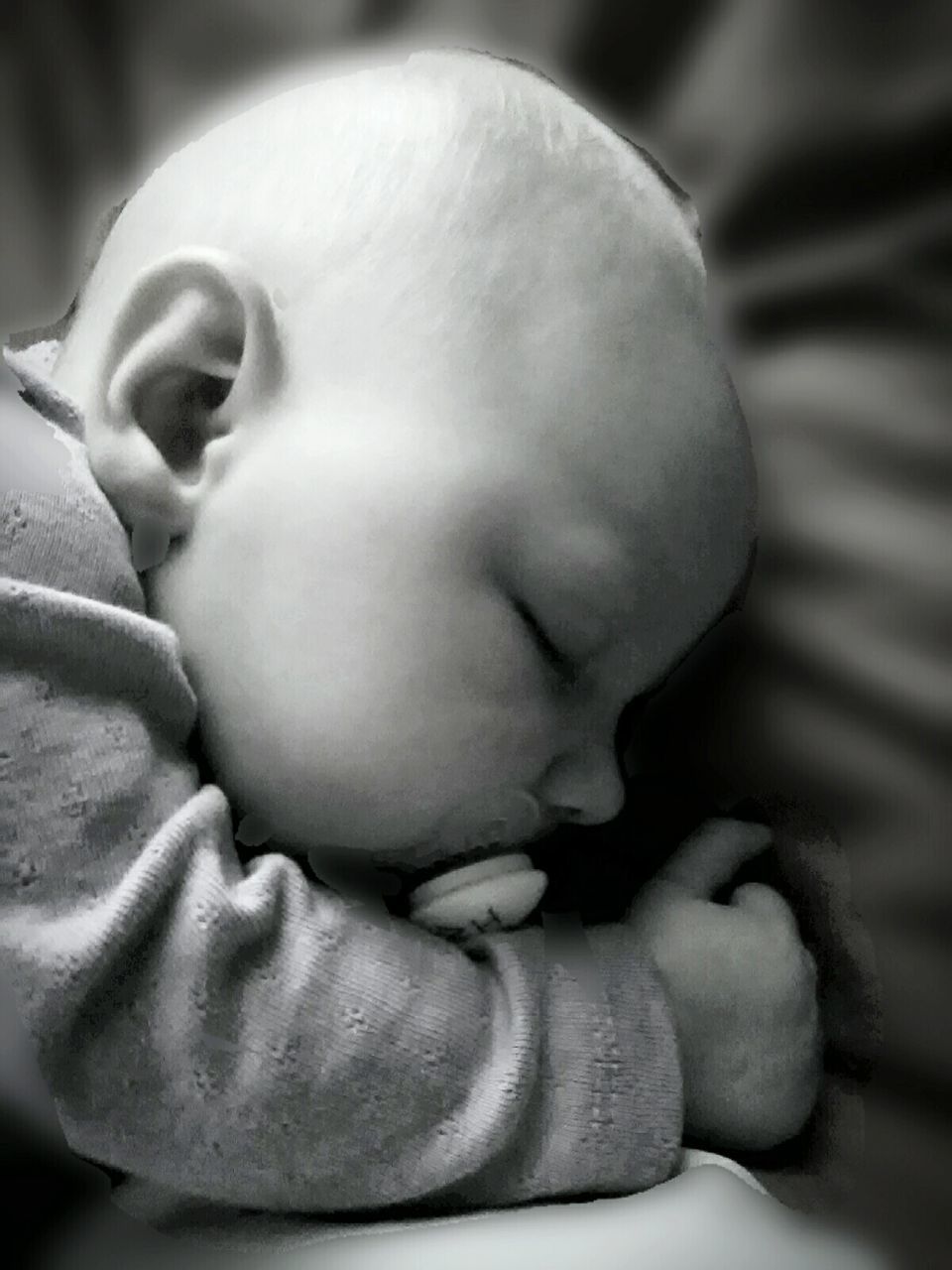 CLOSE-UP OF BABY SLEEPING ON CARPET