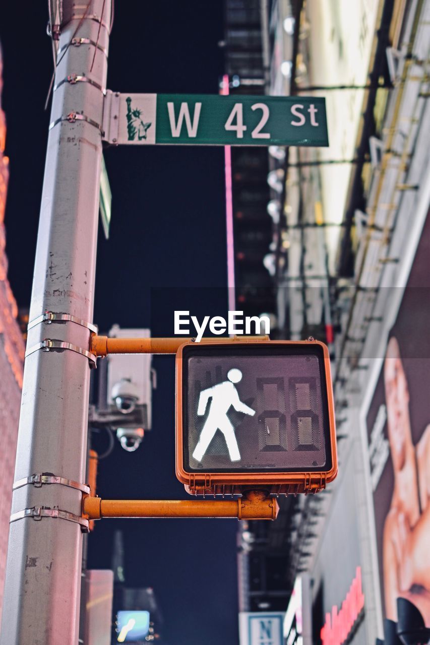 LOW ANGLE VIEW OF ROAD SIGN ON CITY