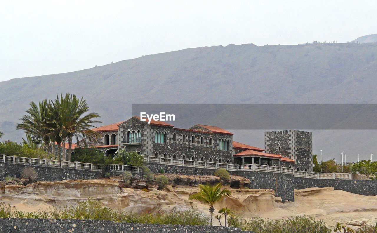 VIEW OF BUILDINGS AGAINST MOUNTAIN