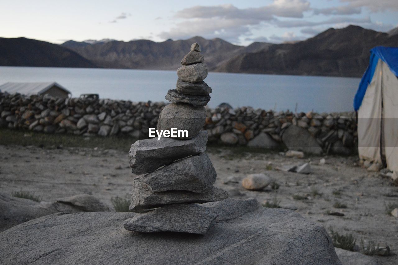 Stack of rocks on beach against sky