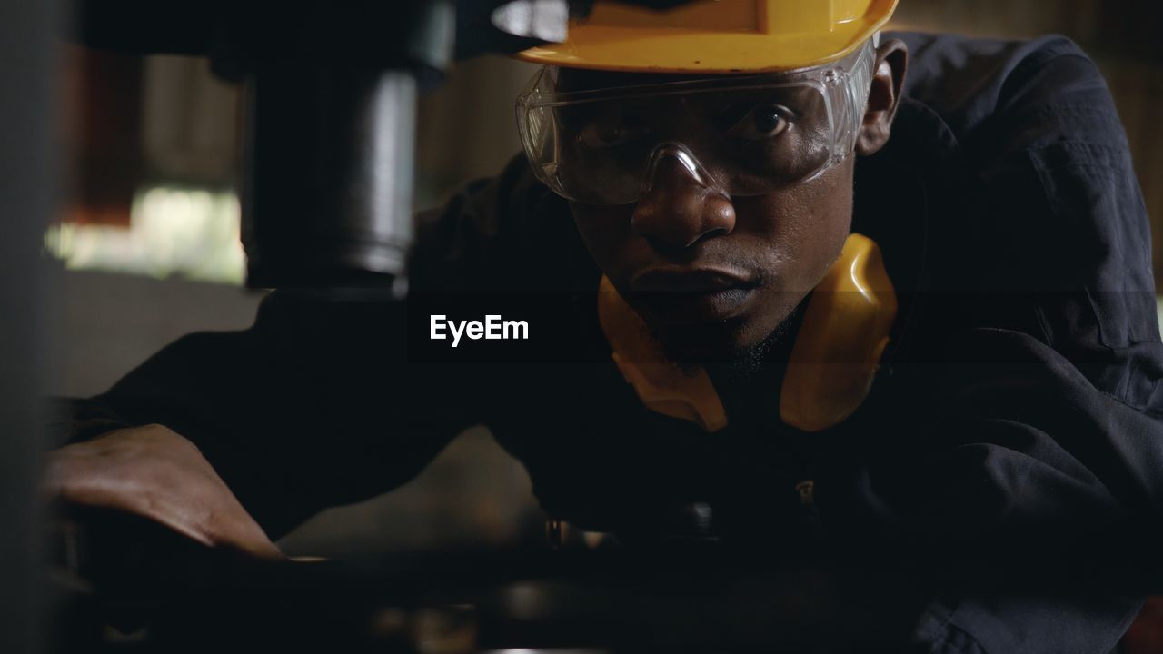 PORTRAIT OF MAN WORKING IN KITCHEN