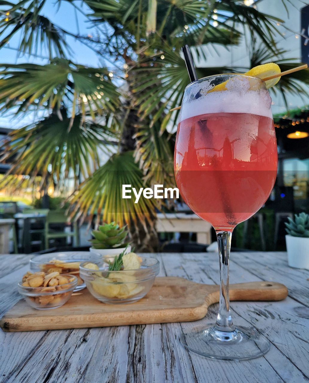 Close-up of drink on table with snack platter 