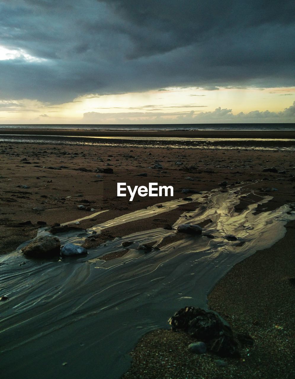 Scenic view of beach against sky during sunset