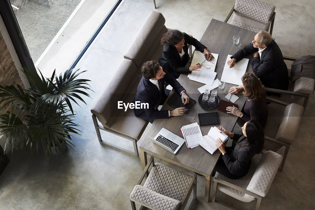 Team of lawyers planning with business colleagues during meeting at law firm