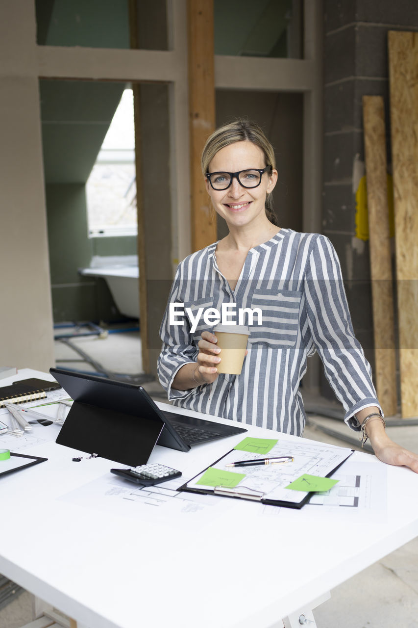 portrait of young businesswoman working at desk in office