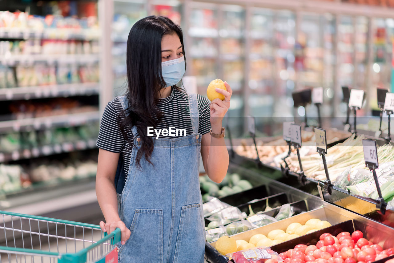 WOMAN HOLDING ICE CREAM AT STORE