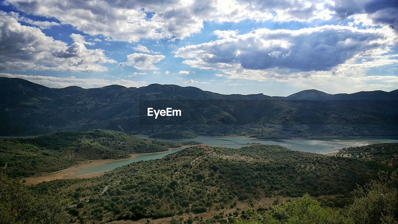 Scenic view of mountains against cloudy sky