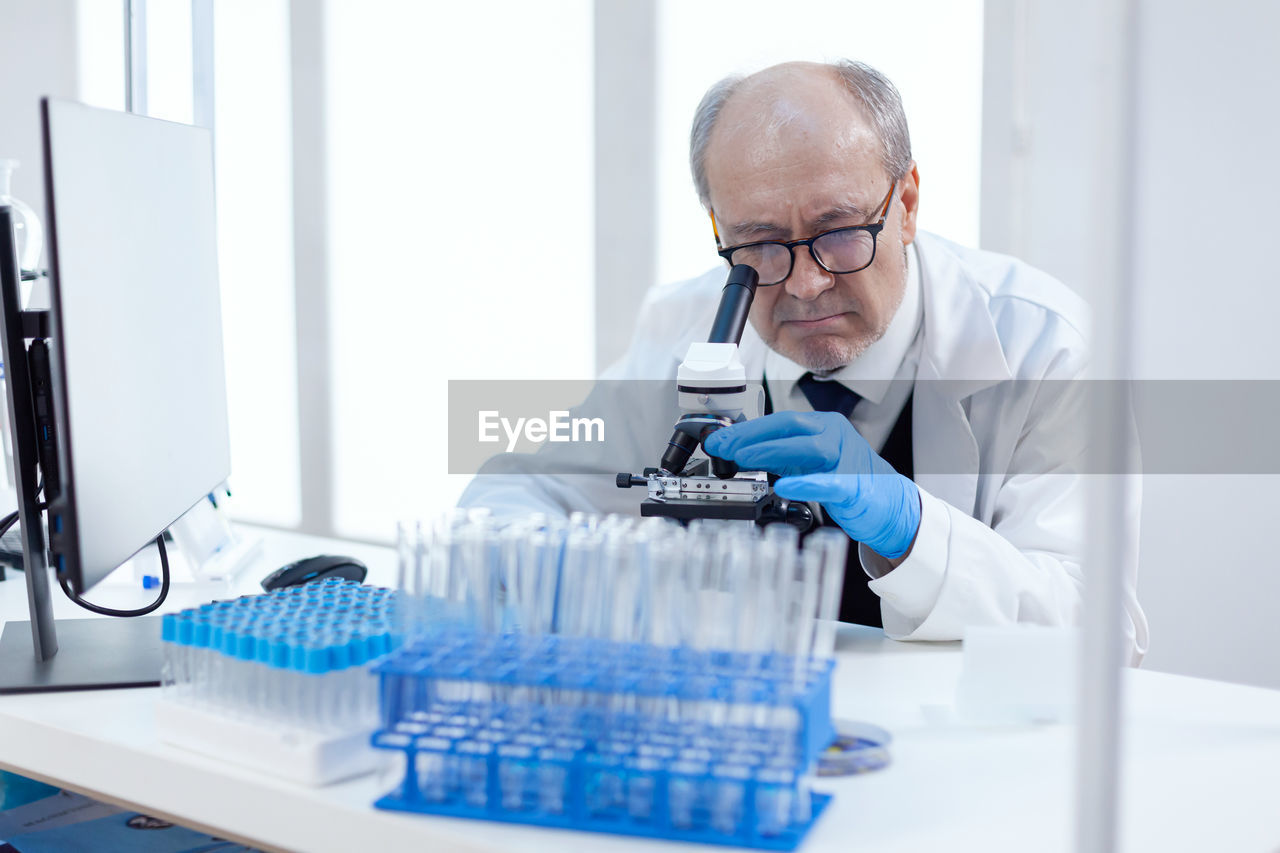 male scientist examining chemical in laboratory