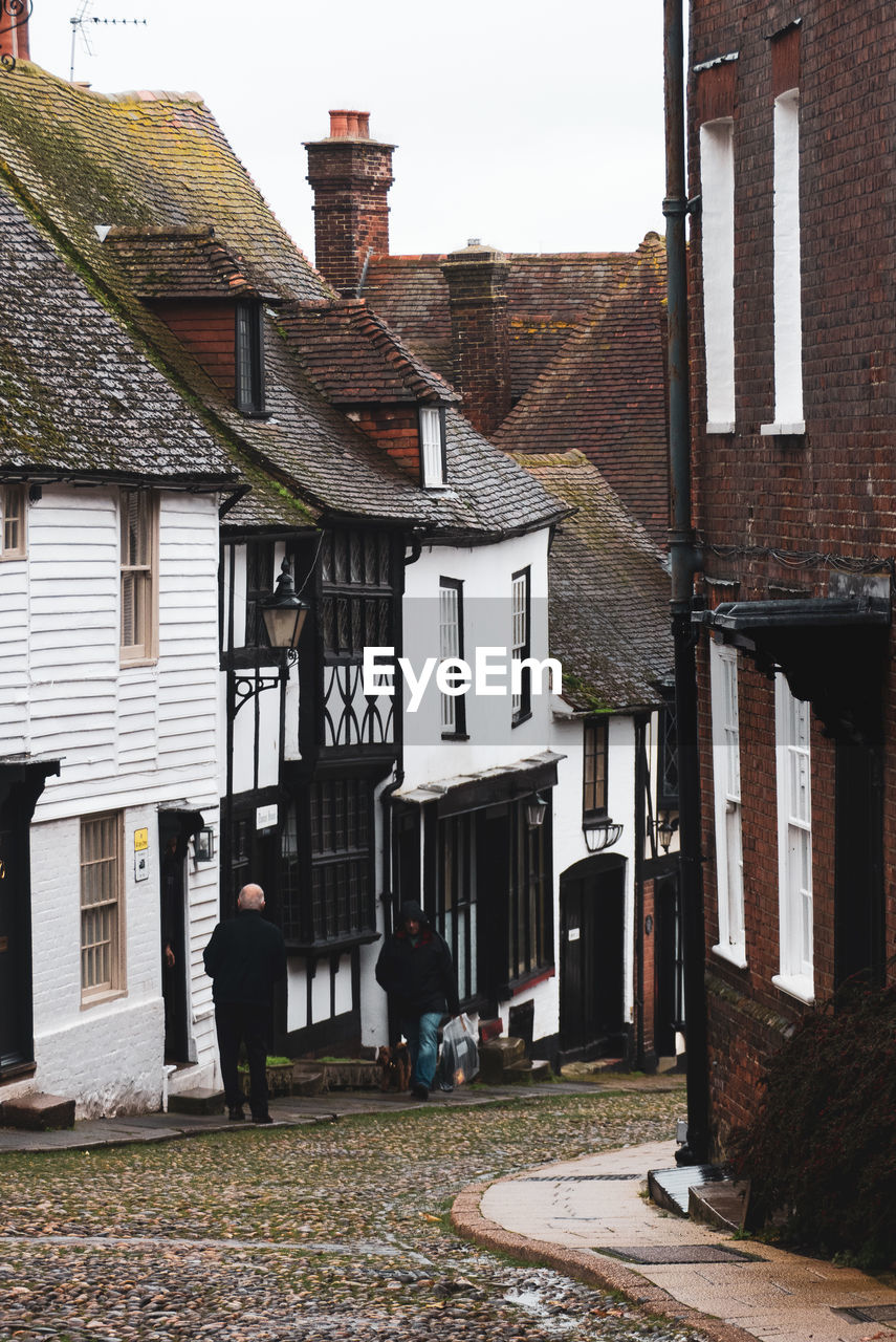 People on old building in rye