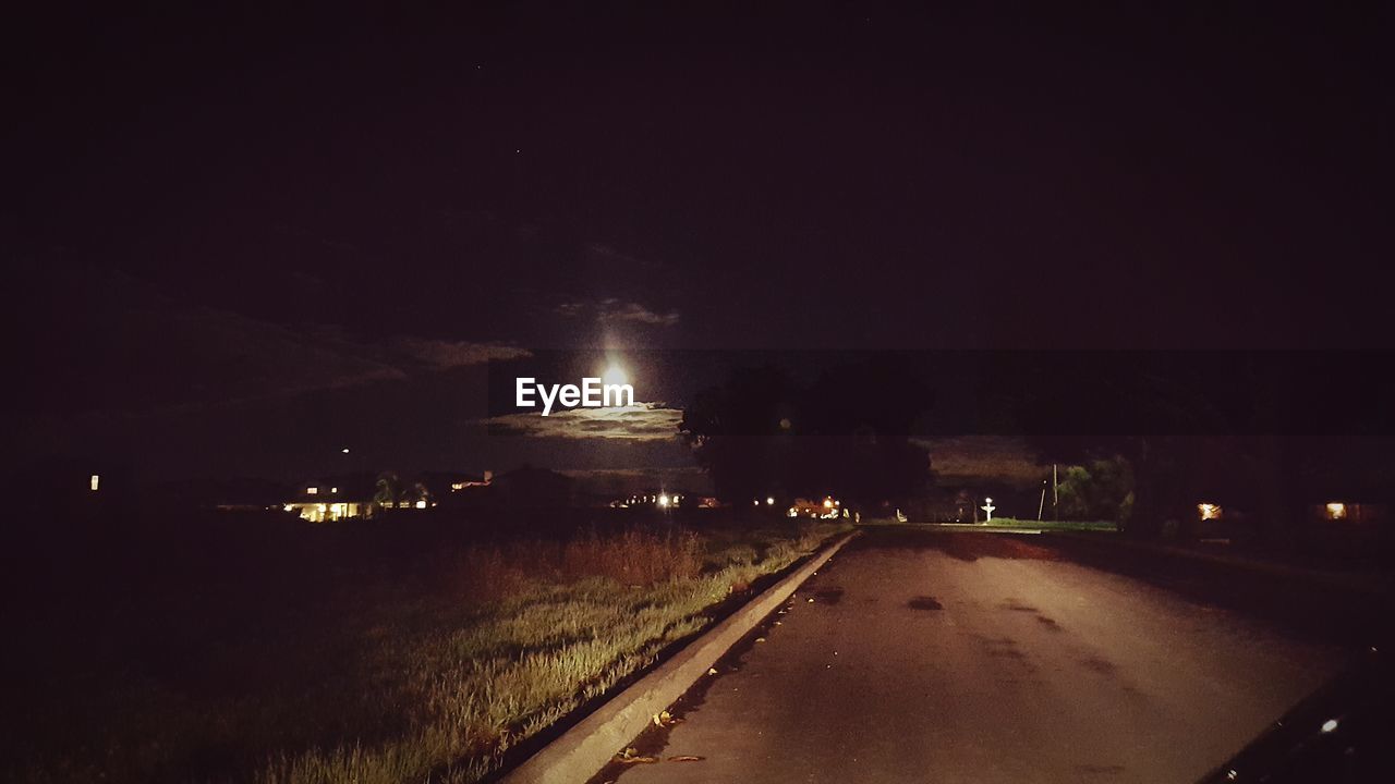 ILLUMINATED LIGHT TRAILS IN SKY AT NIGHT