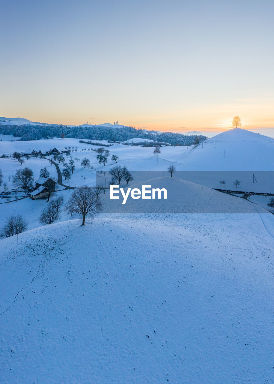 scenic view of snow covered landscape against clear sky