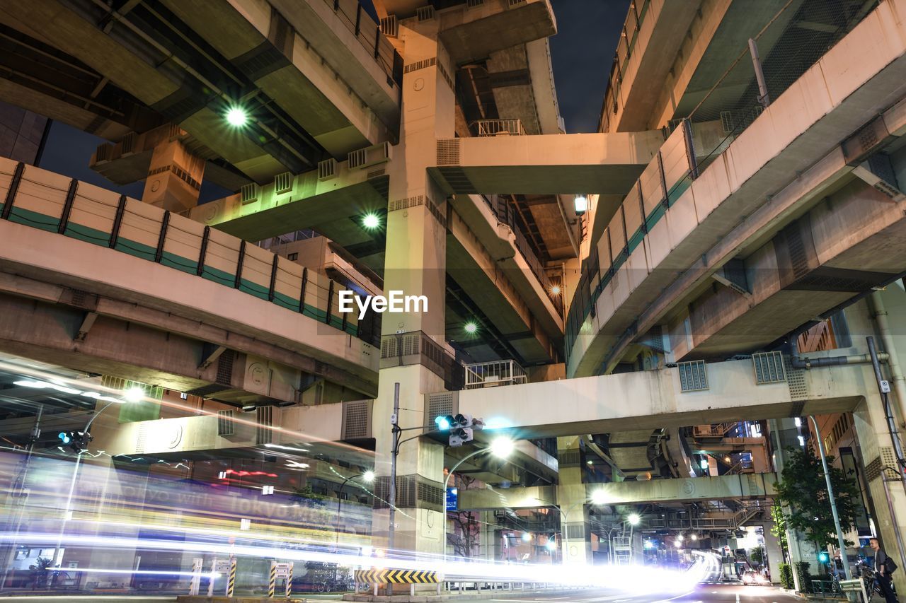 Low angle view of illuminated street lights at night