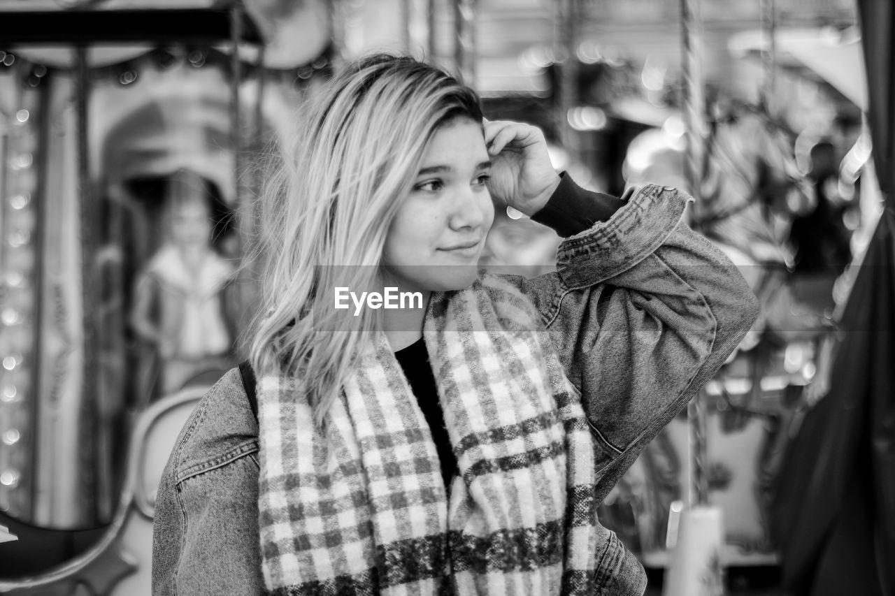 Woman looking away while standing outdoors