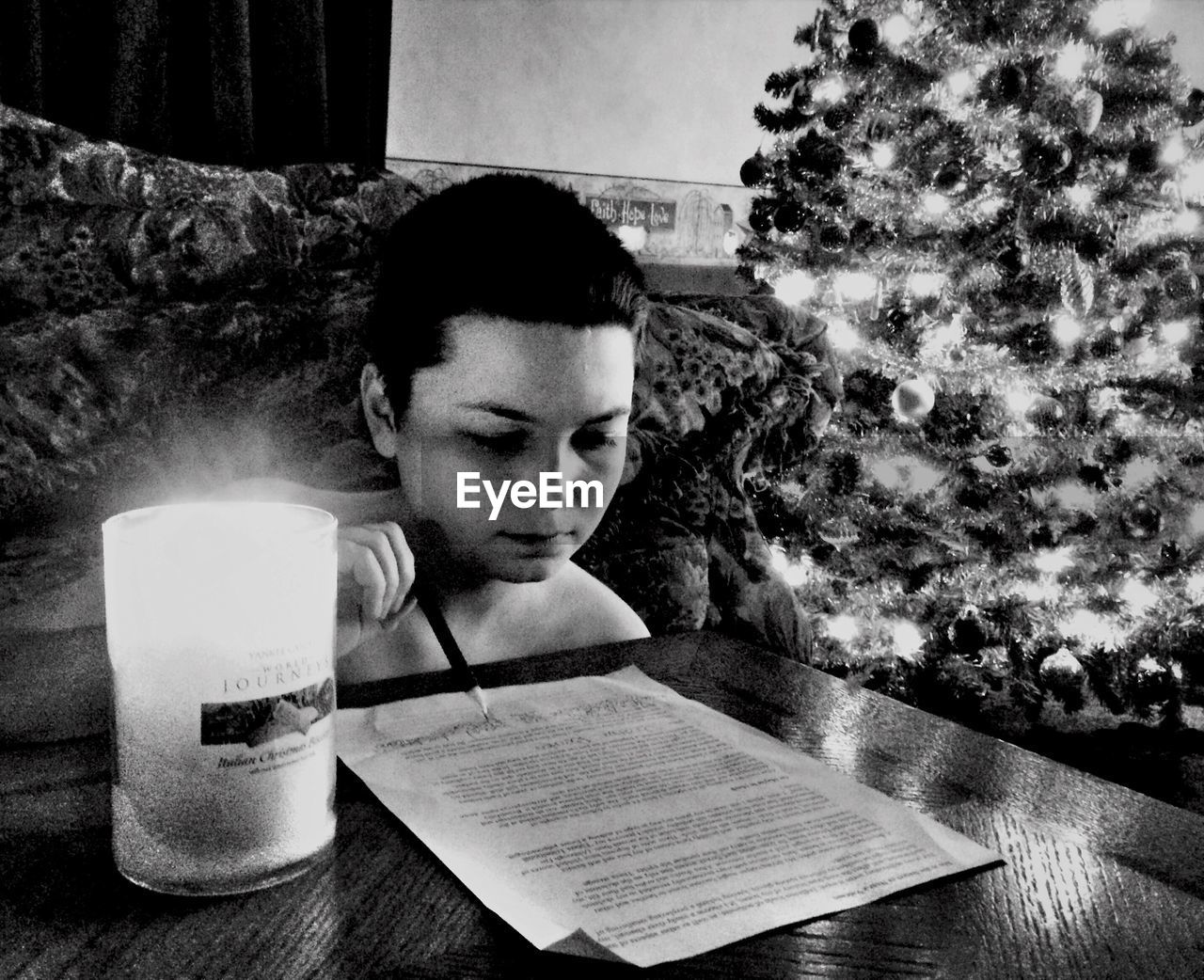 Concentrated young boy reading document