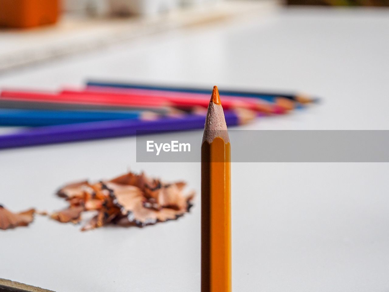 Close-up of colored pencil by table