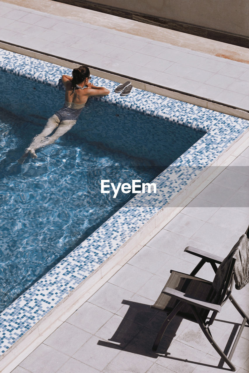 High angle view of woman swimming in pool