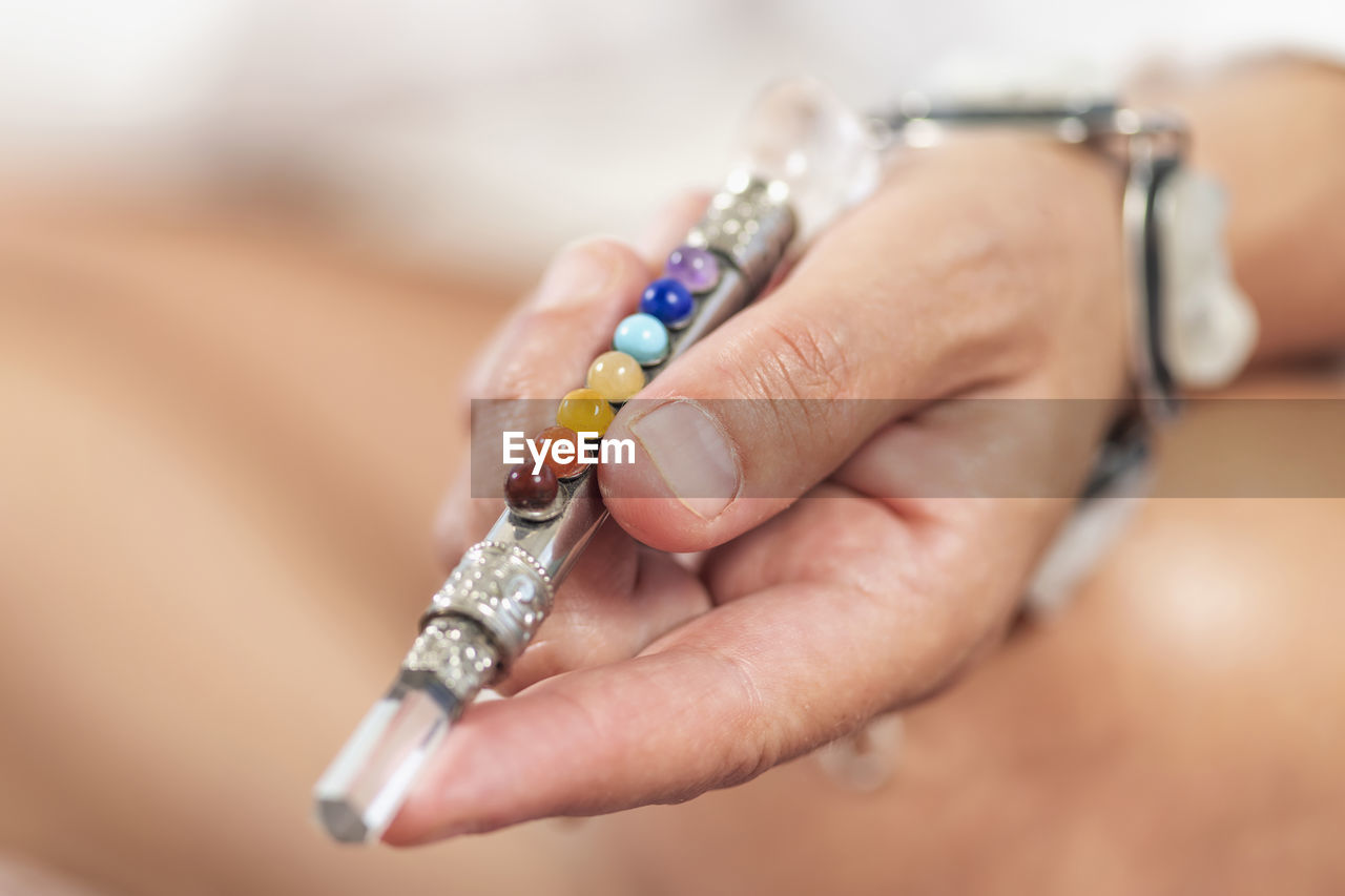 Midsection of woman holding crystal