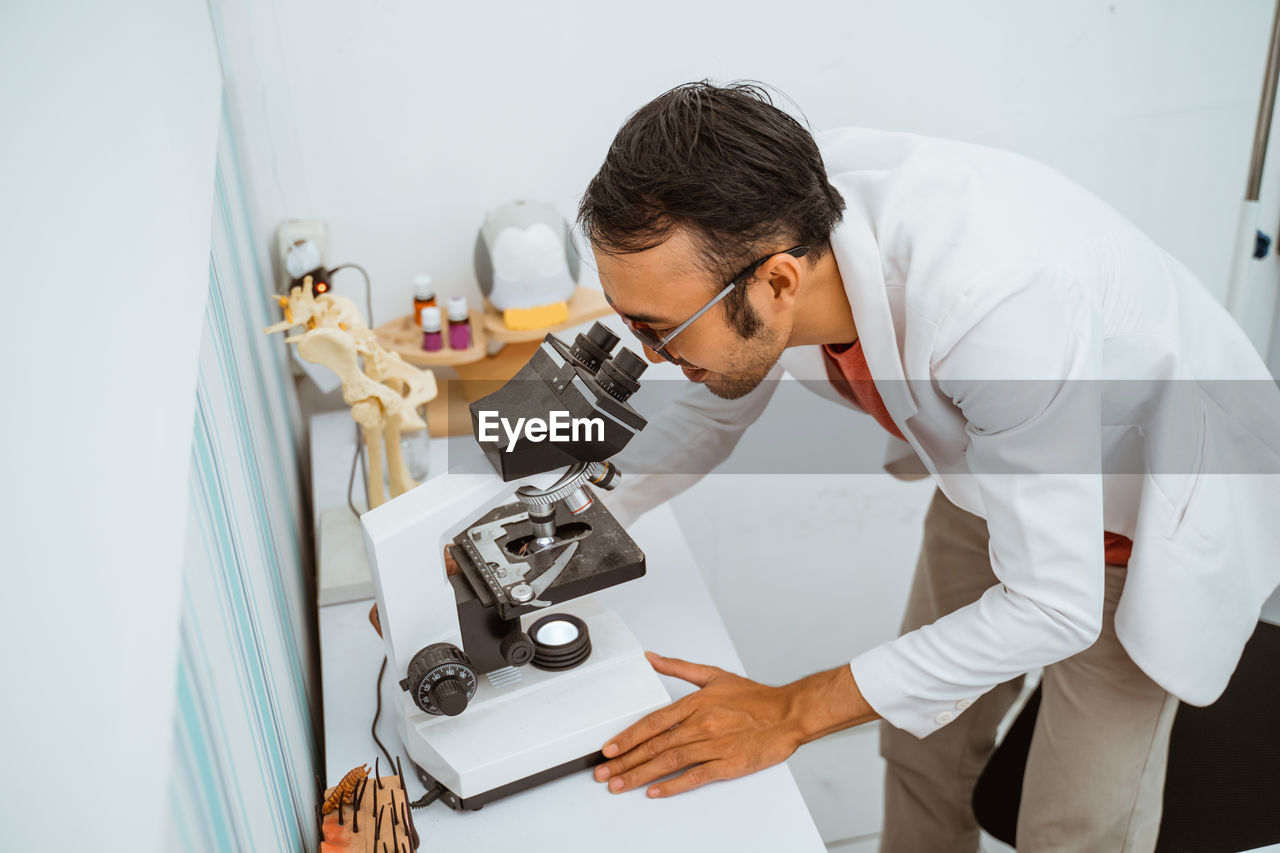 side view of doctor working in kitchen