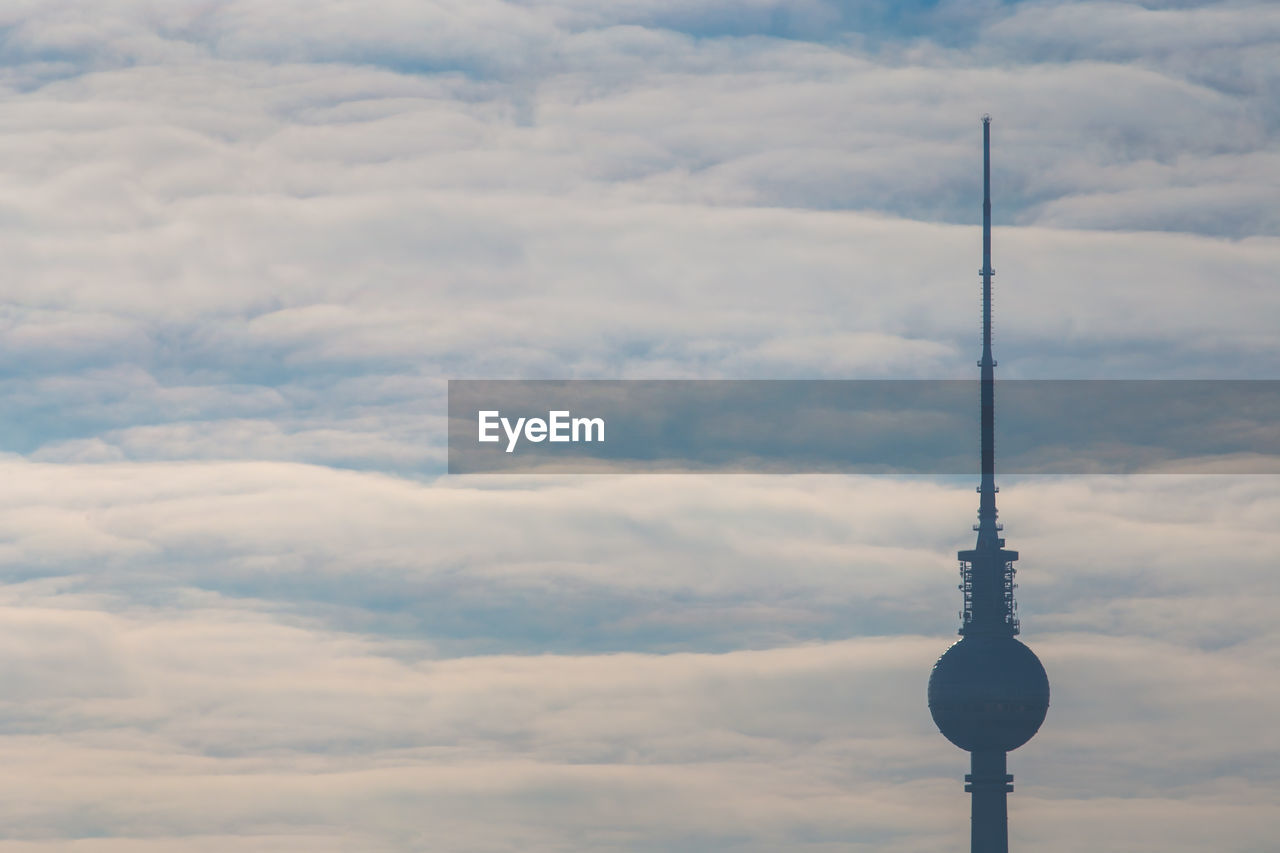 Fernsehturm against cloudy sky