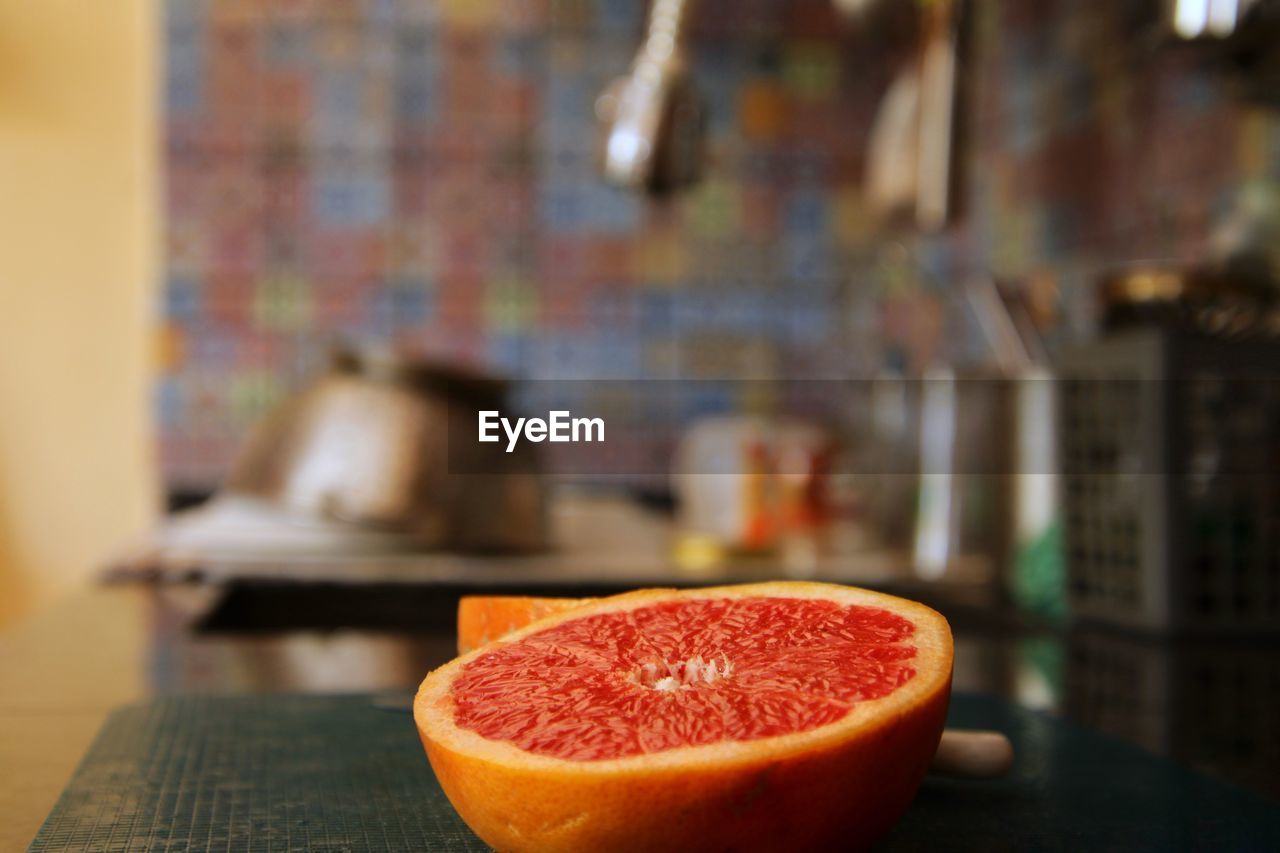 Close-up of grapefruit on table at home