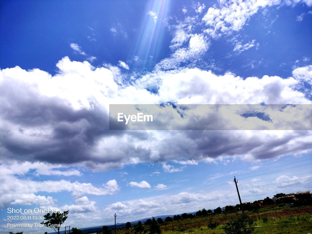 sky, cloud, environment, nature, horizon, beauty in nature, landscape, sunlight, scenics - nature, blue, plant, tree, no people, cloudscape, land, tranquility, outdoors, tranquil scene, day, sunbeam, non-urban scene, grass, low angle view, travel, idyllic, dramatic sky, mountain