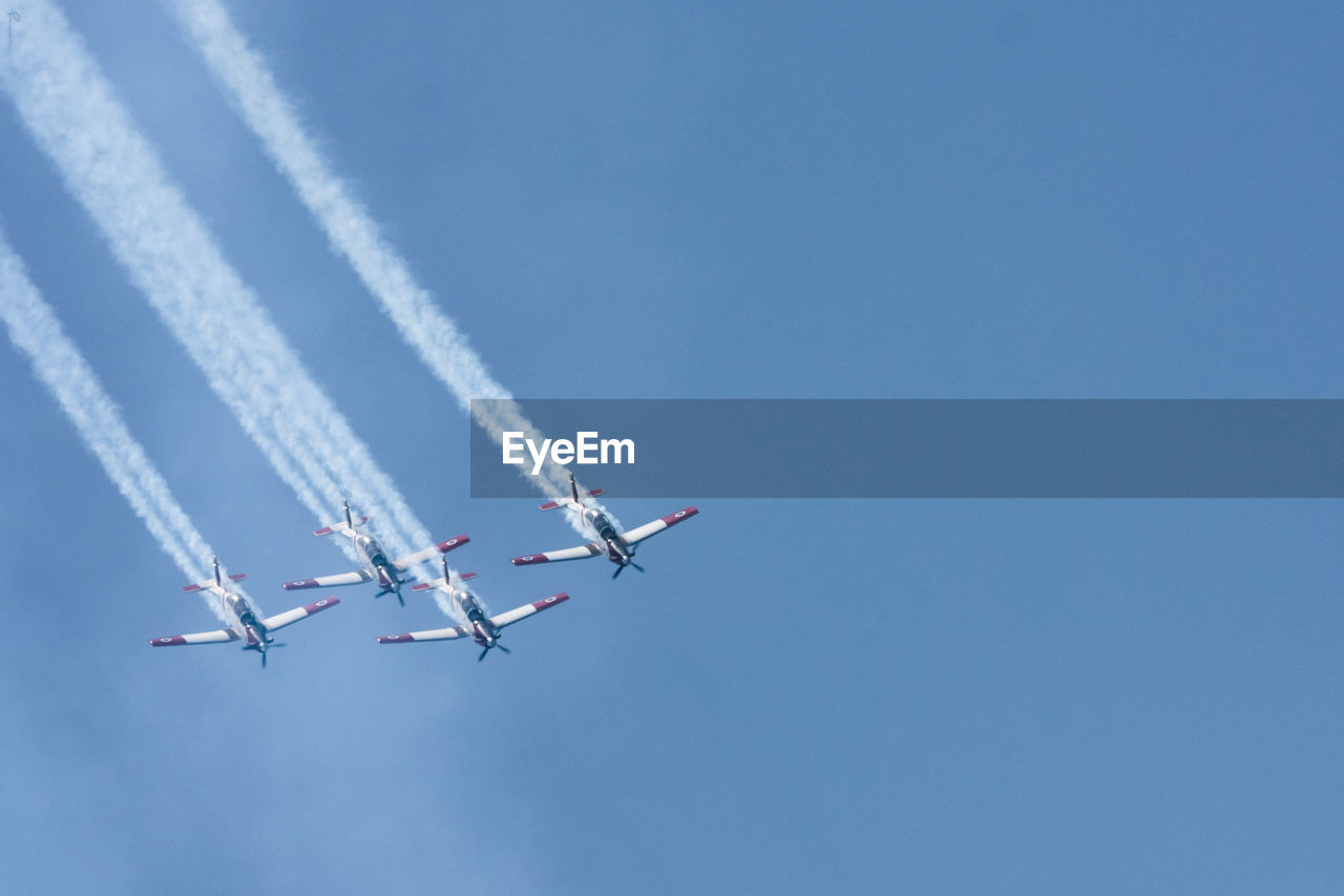 LOW ANGLE VIEW OF AIRPLANE FLYING IN SKY