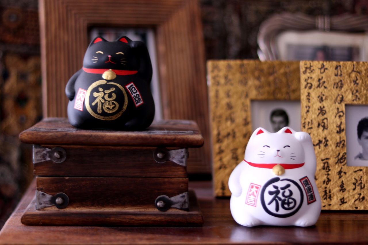 Close-up of japanese figurines on table at home