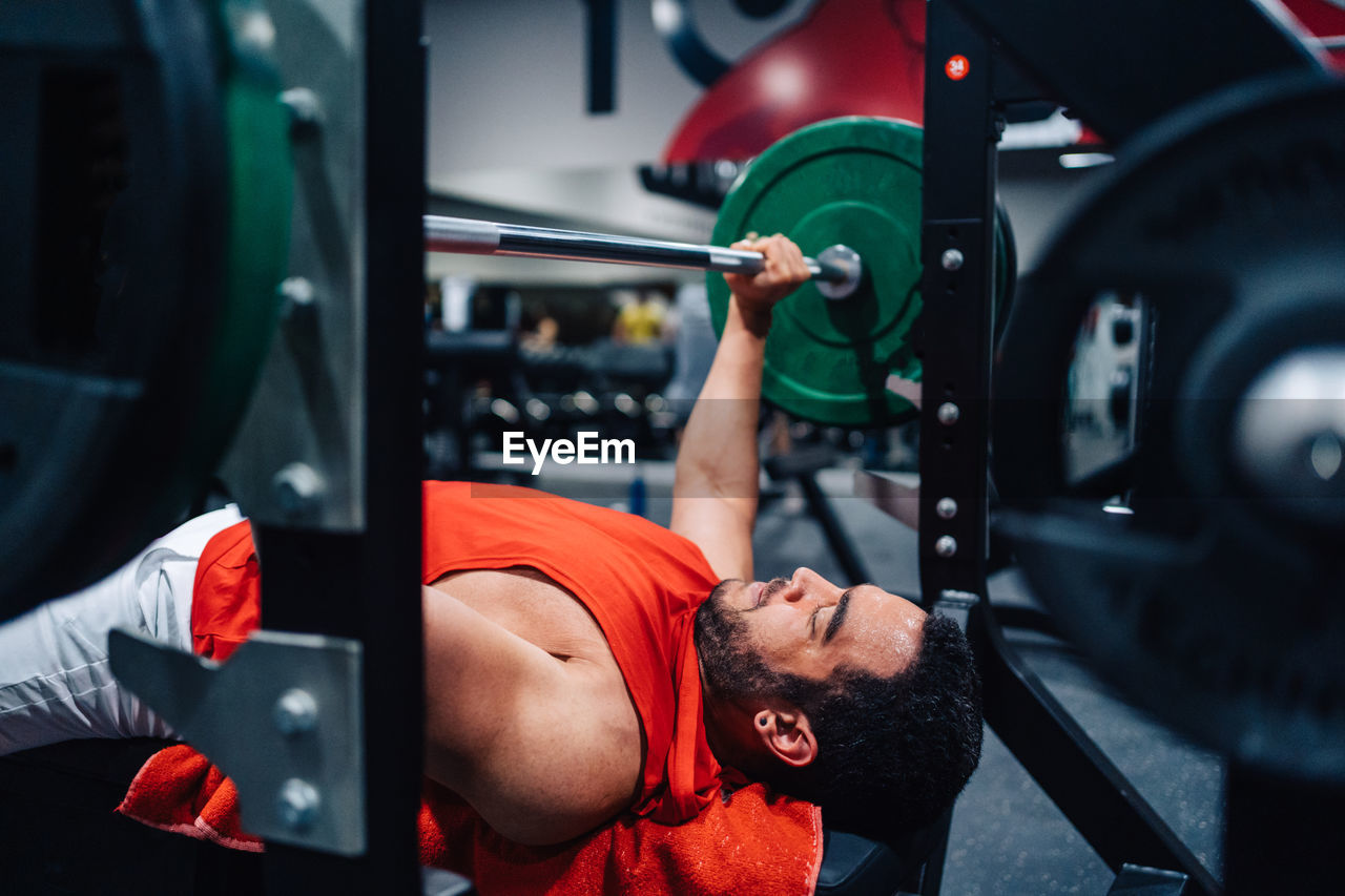 Rear view of man exercising in gym