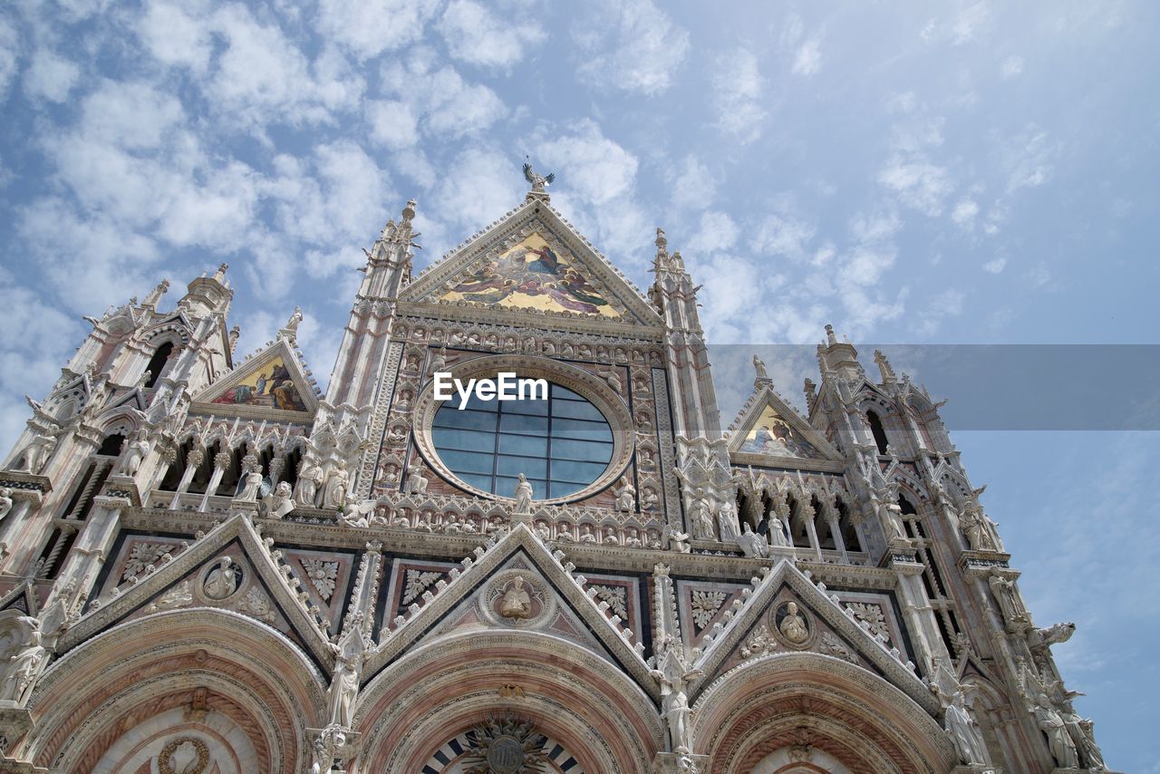 LOW ANGLE VIEW OF ORNATE CATHEDRAL AGAINST SKY