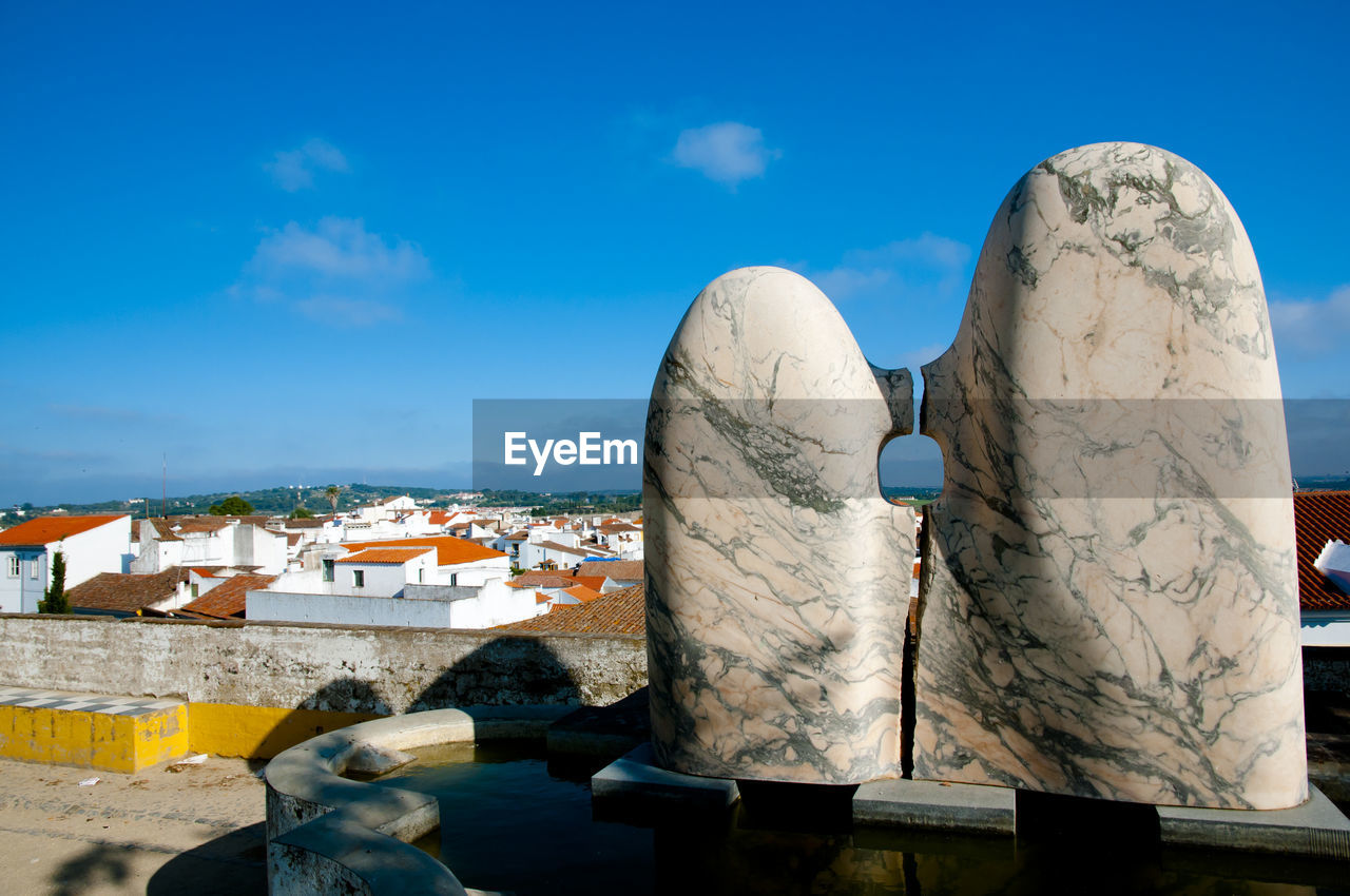 CLOSE-UP OF SCULPTURE AGAINST BLUE SKY