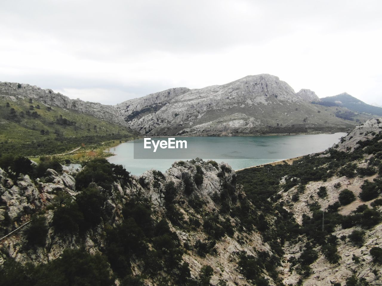 Scenic view of sea and mountains against sky