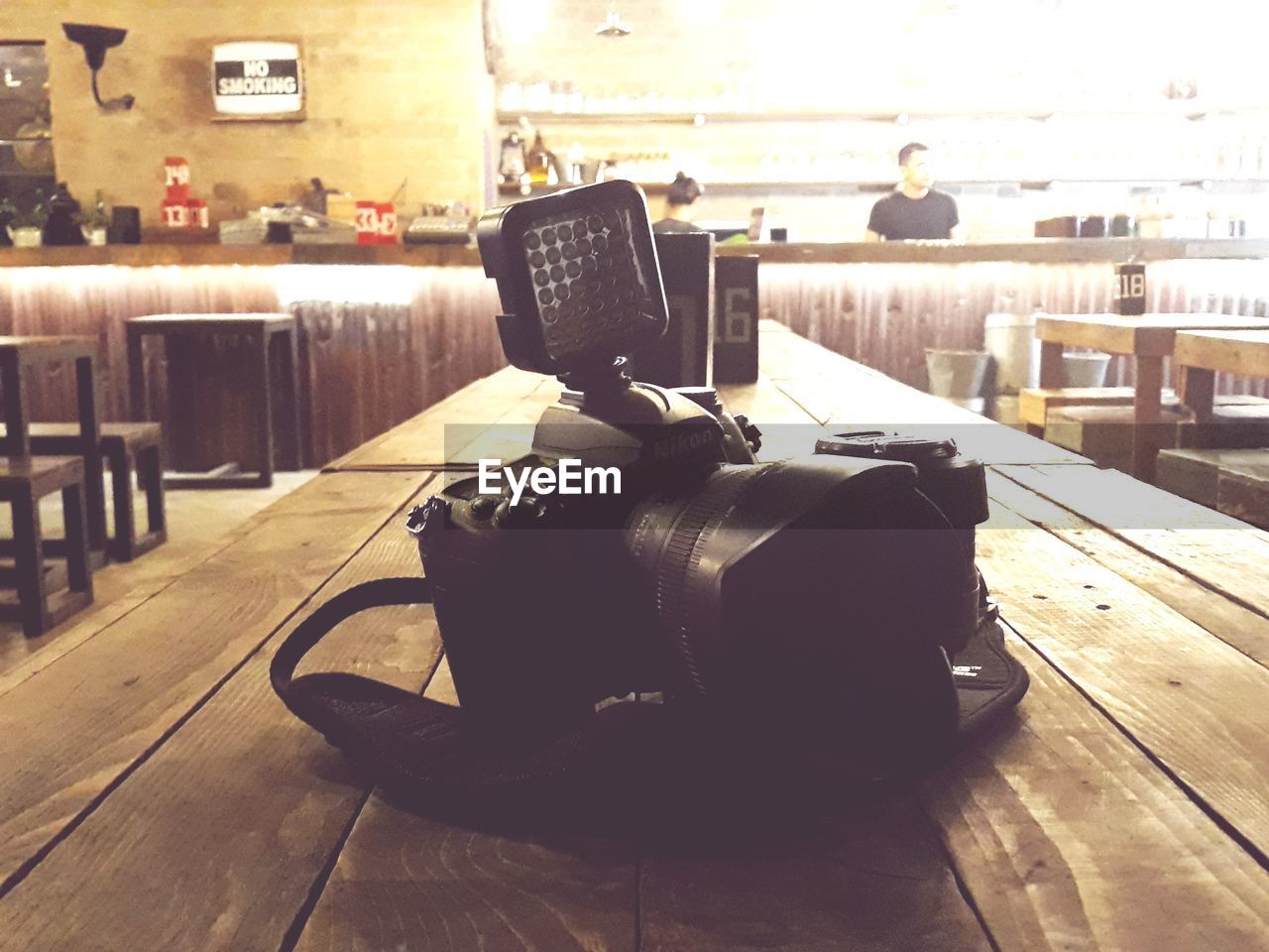 CLOSE-UP OF CAMERA ON TABLE IN CAFE