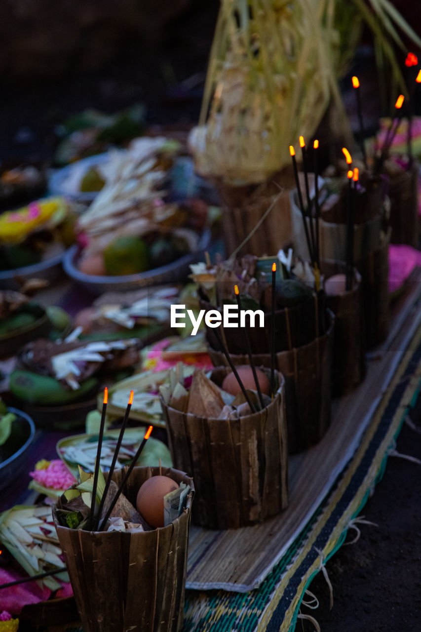 flower, food and drink, no people, food, plant, candle, flowering plant, nature, container, outdoors, table, tradition, freshness, decoration, celebration