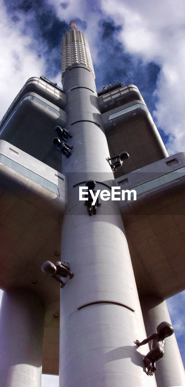 LOW ANGLE VIEW OF BUILDING AGAINST CLOUDS