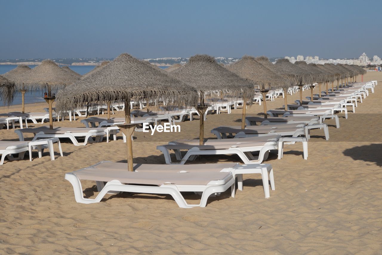Deck chairs arranged at beach