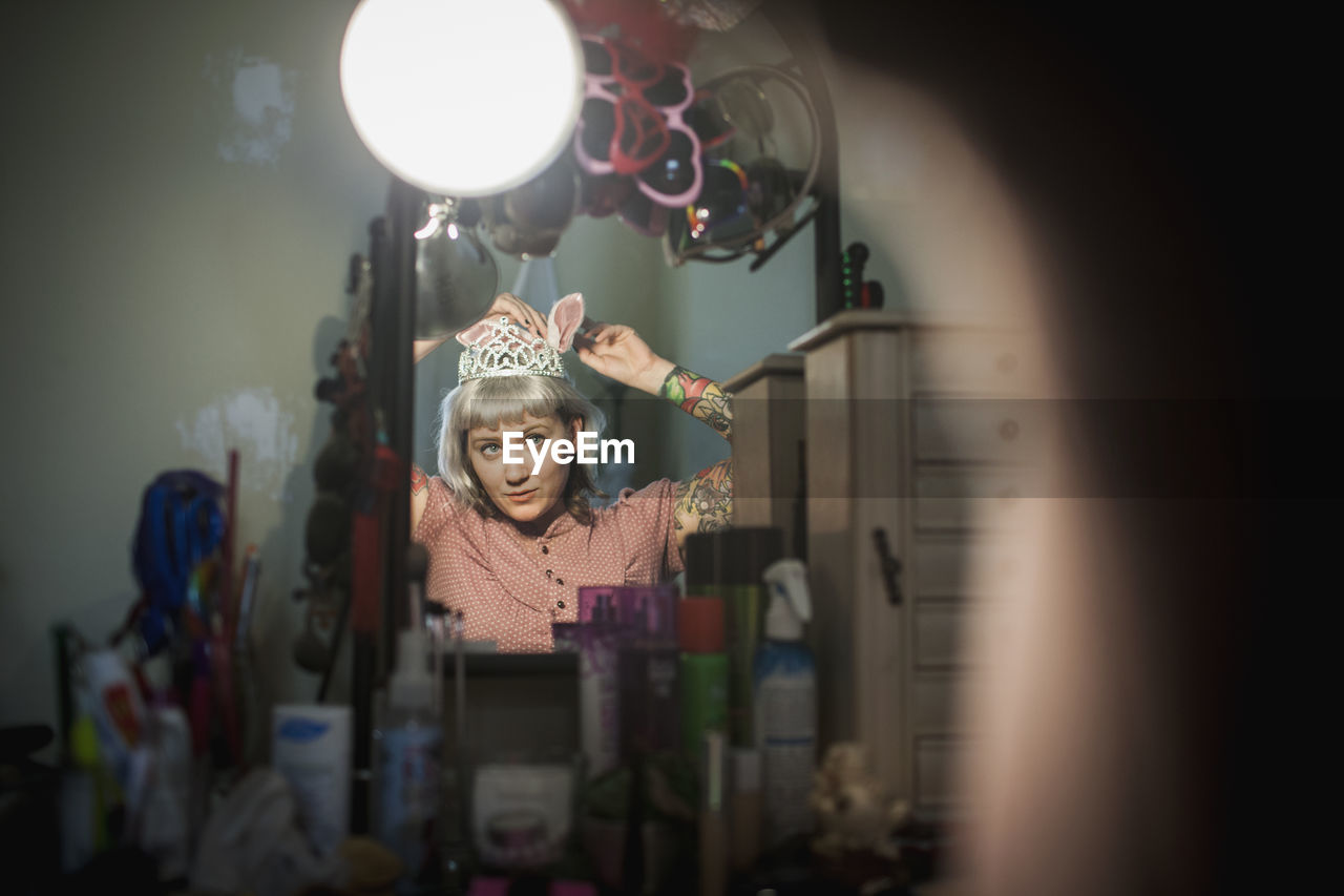 Young woman in front of mirror