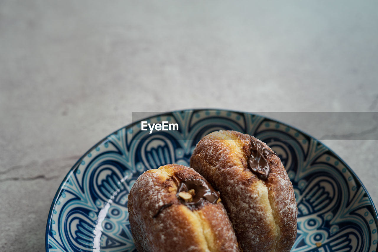 Bomboloni, a donut filled with melted chocolate and eaten as a snacks. originated from italy.