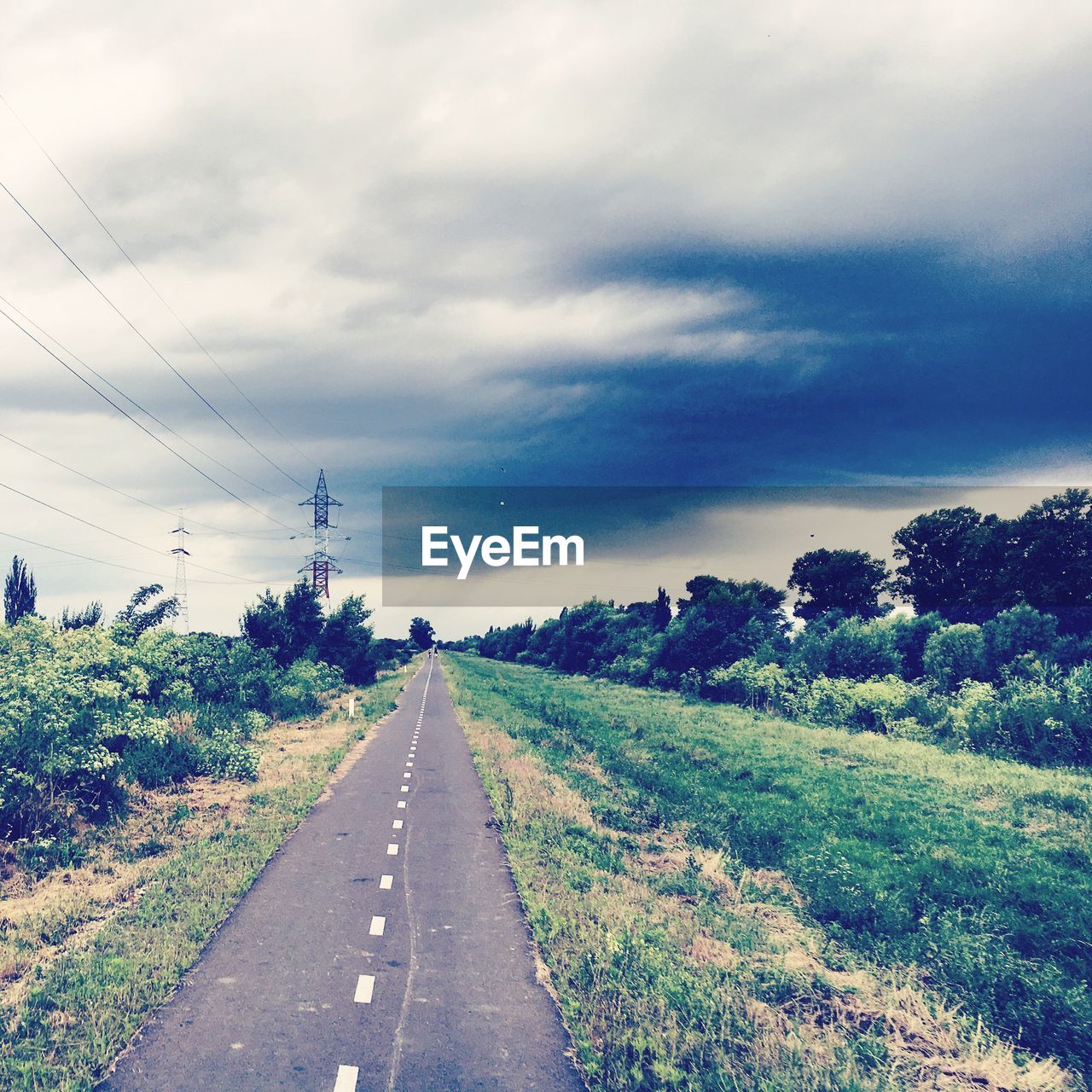 VIEW OF FIELD AGAINST CLOUDY SKY