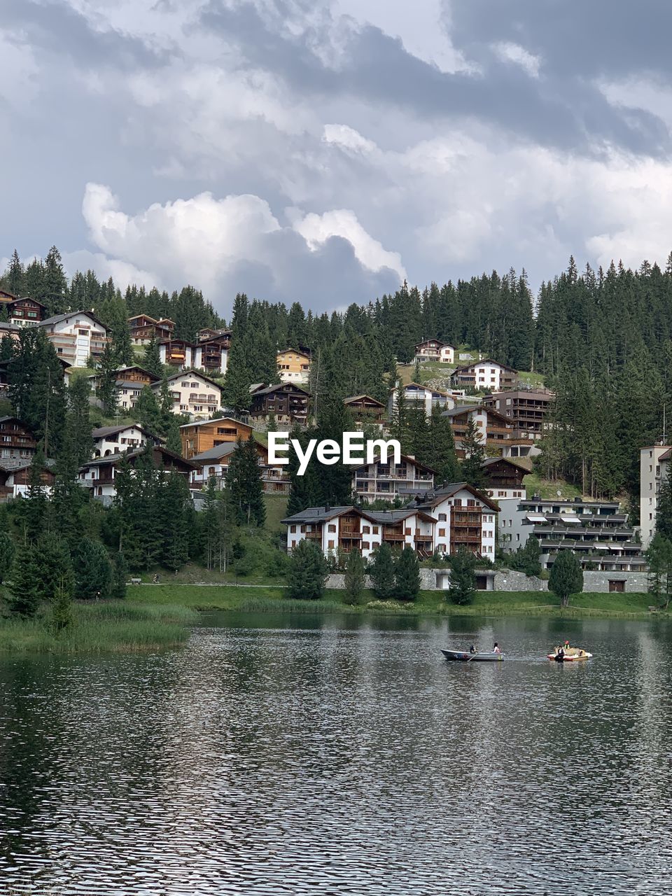 Scenic view of lake by buildings against sky