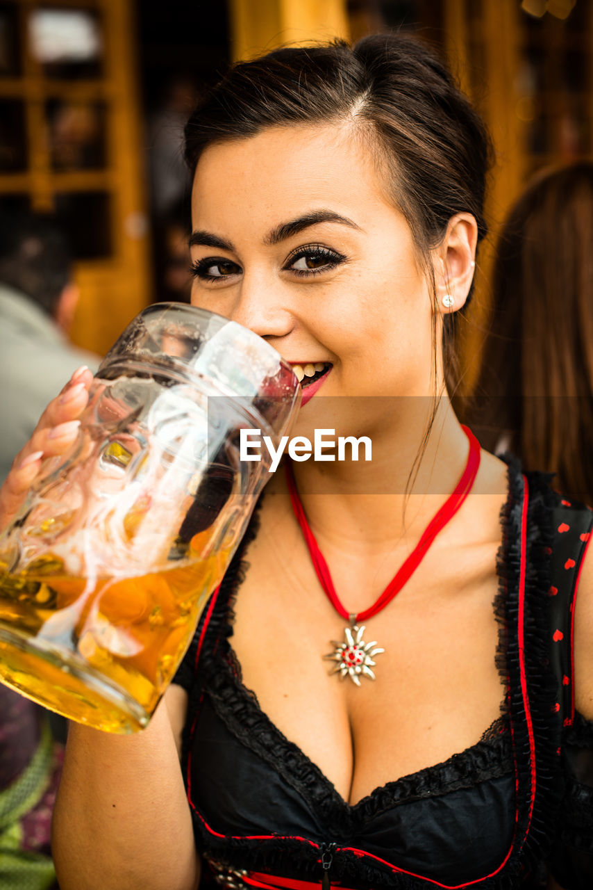 Portrait of woman drinking beer at oktoberfest