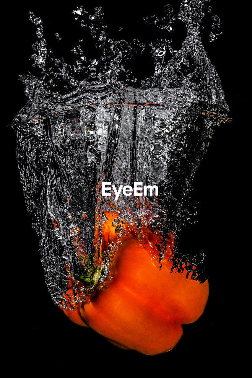 Close-up of bell pepper against black background