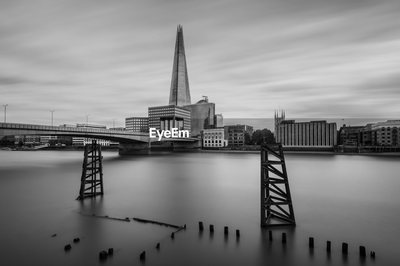 Bridge over river with buildings in background