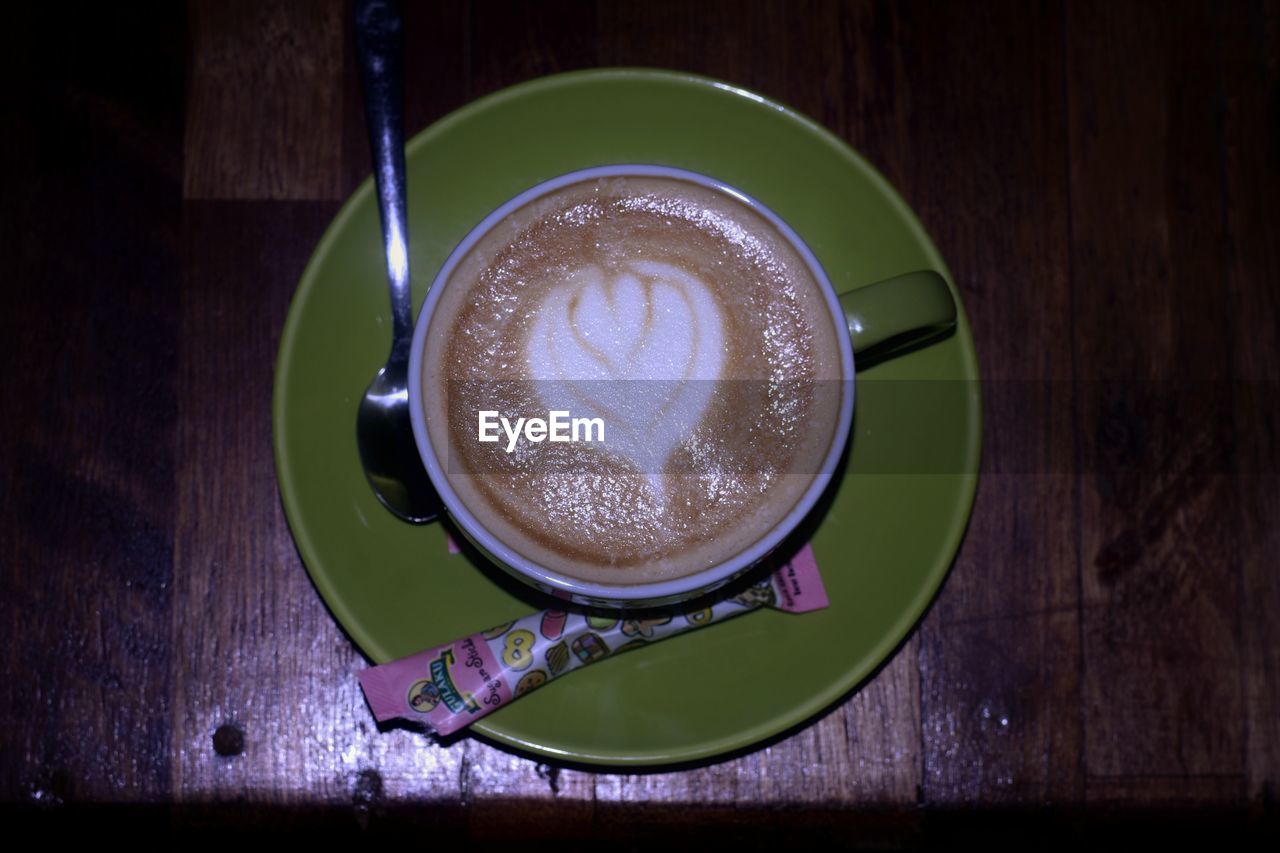 food and drink, drink, cup, table, mug, refreshment, coffee, saucer, coffee cup, crockery, still life, green, frothy drink, hot drink, wood, freshness, indoors, directly above, kitchen utensil, food, no people, cappuccino, eating utensil, spoon, high angle view, close-up, froth art, latte