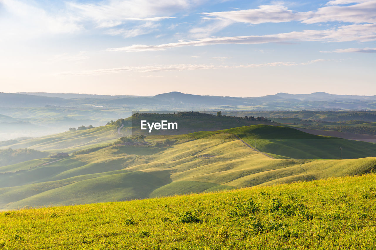 Rolling rural landscape view with morning mists in the valley