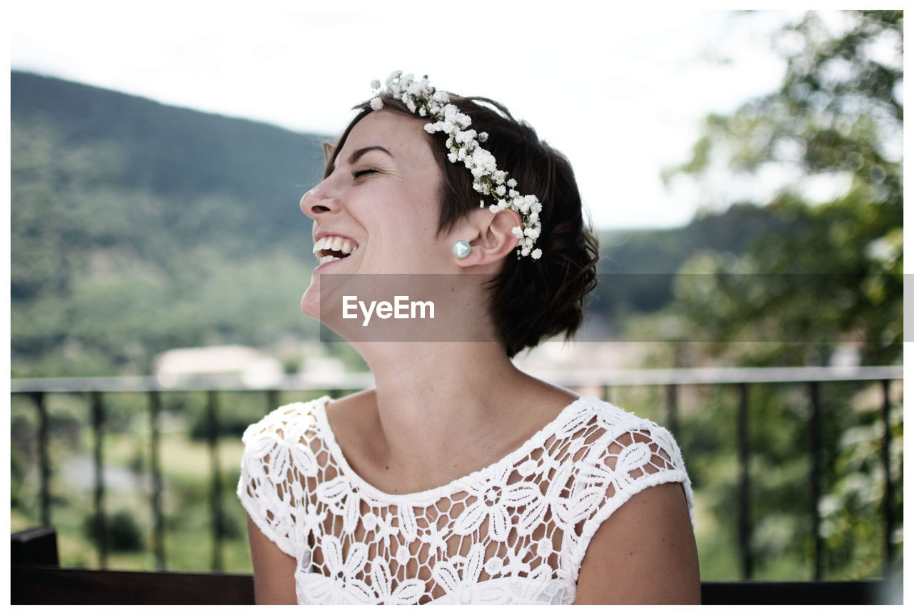 Close-up of happy young woman looking away