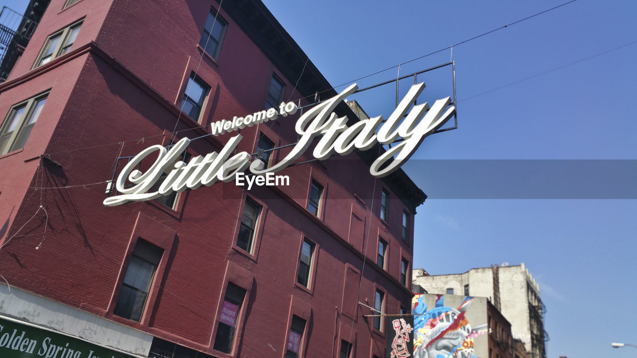 Low angle view of welcome sign against building