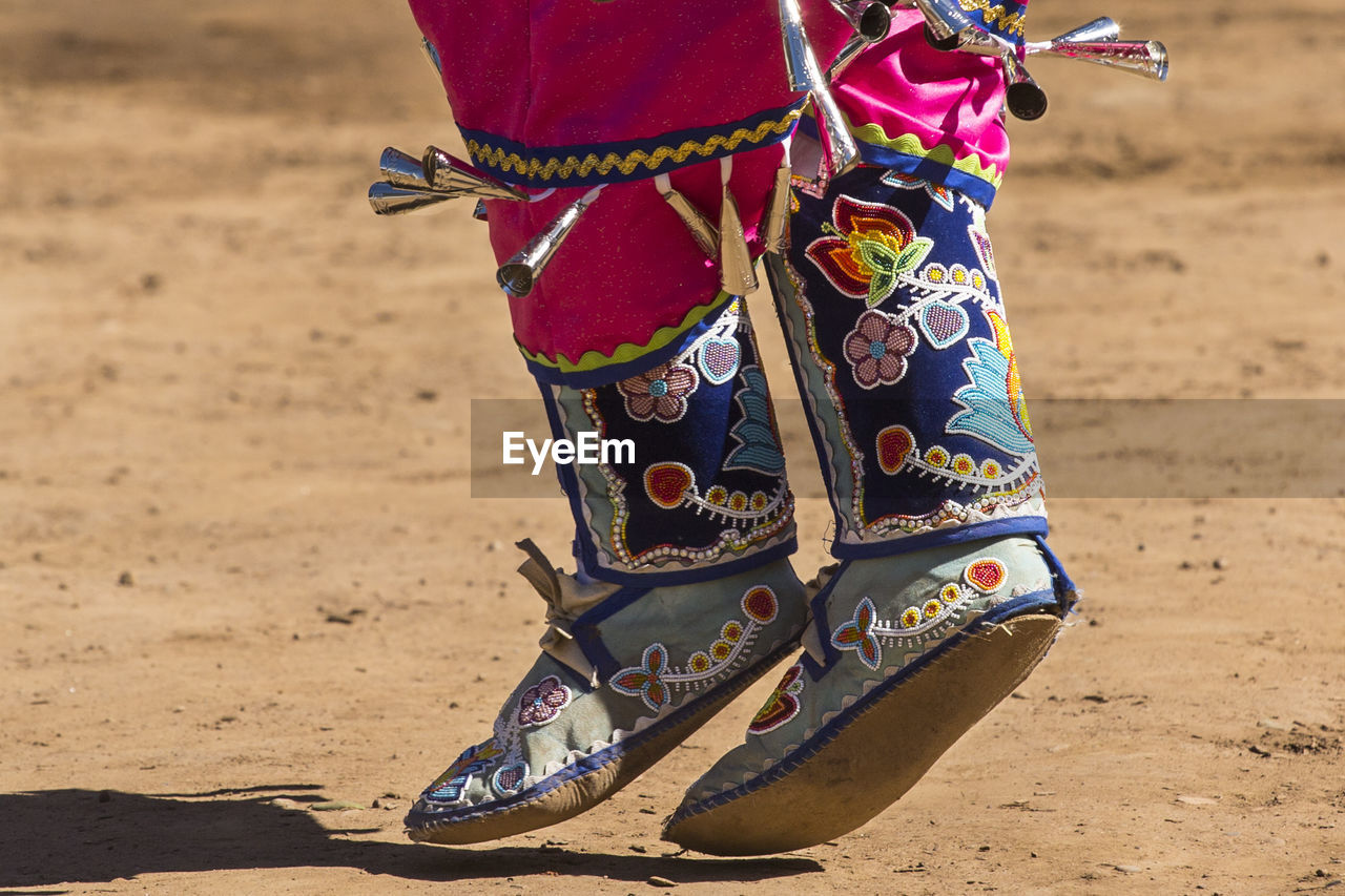 Low section of man dancing on field