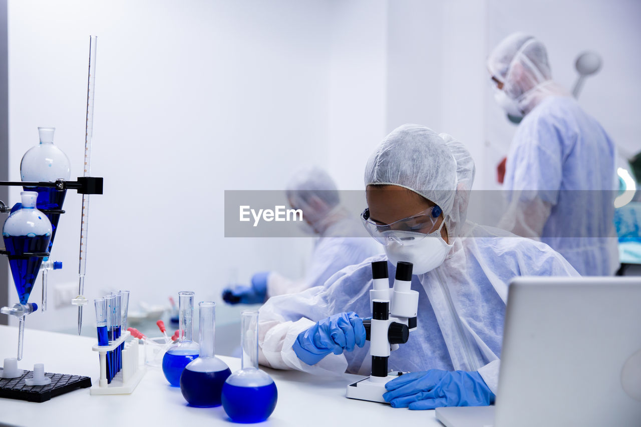 female scientist examining chemical in laboratory